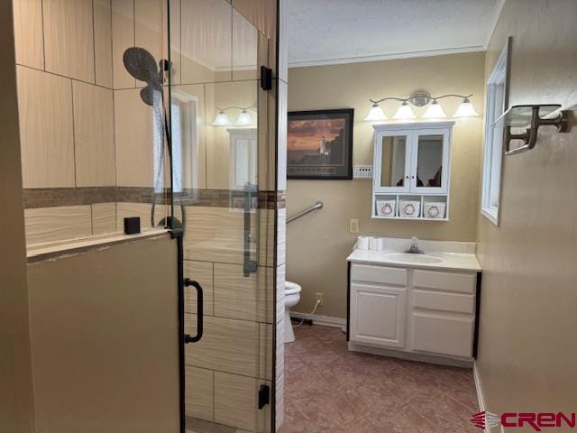 bathroom featuring vanity, toilet, and a shower with shower door