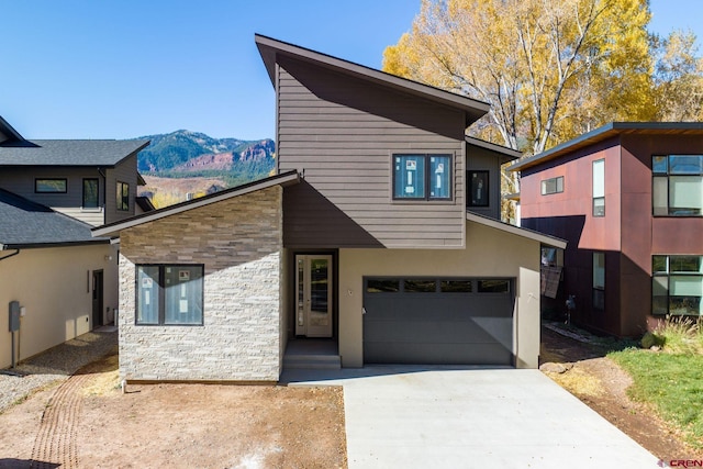 contemporary house featuring a garage and a mountain view