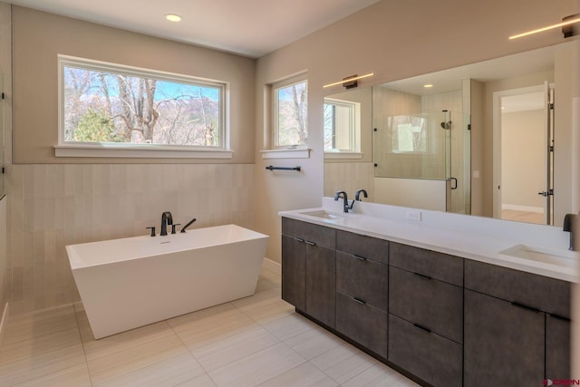 538 Hermosa Meadows Rd, Durango, CO 81301 - full bath featuring a shower stall, double vanity, tile patterned flooring, a soaking tub, and tile walls