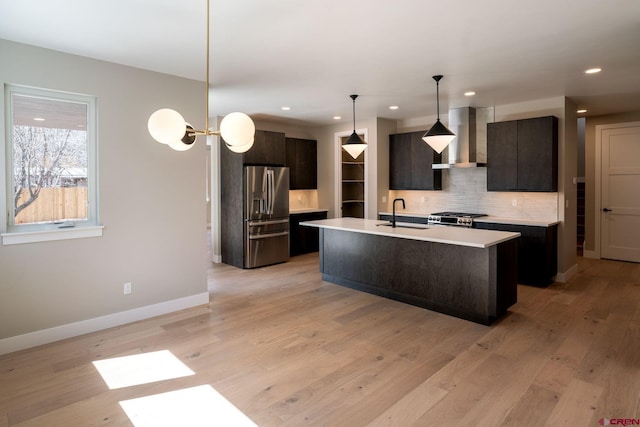 538 Hermosa Meadows Rd, Durango, CO 81301 - kitchen with stainless steel refrigerator with ice dispenser, wall chimney range hood, range, backsplash, and light countertops