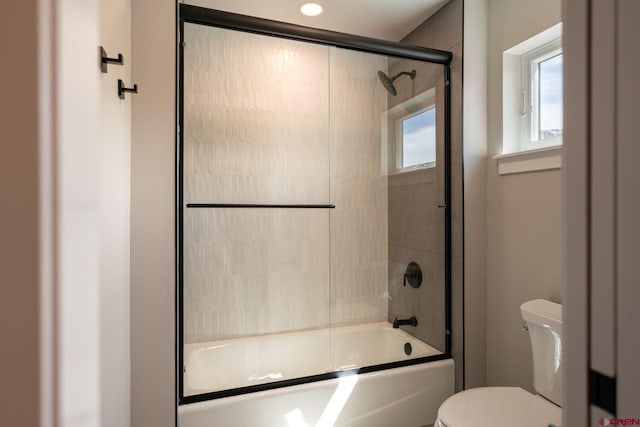 538 Hermosa Meadows Rd, Durango, CO 81301 - bathroom featuring toilet and bath / shower combo with glass door