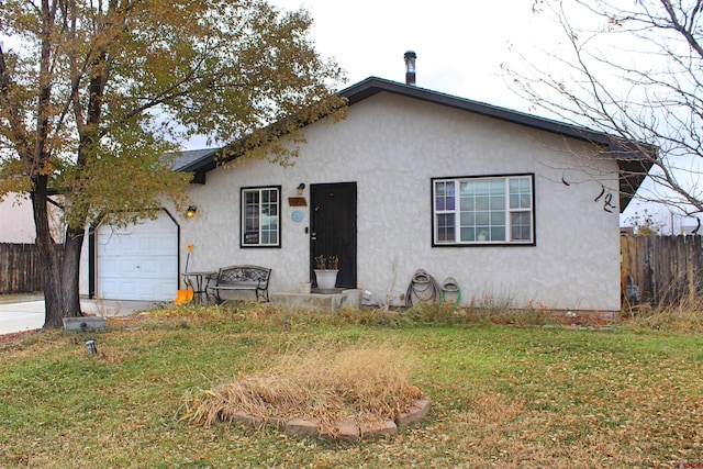 view of front of property with a front yard and a garage