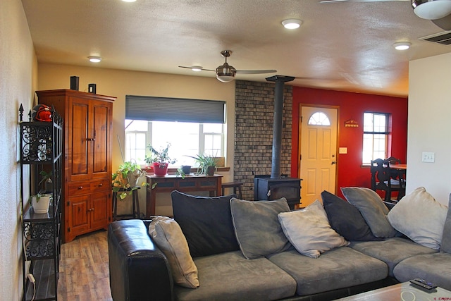 living room featuring a wood stove and hardwood / wood-style floors