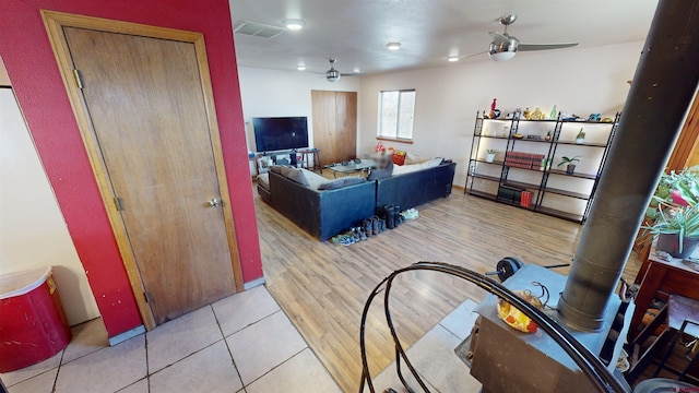 living room featuring ceiling fan and light hardwood / wood-style flooring