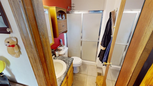 bathroom featuring vanity, toilet, tile patterned floors, and walk in shower