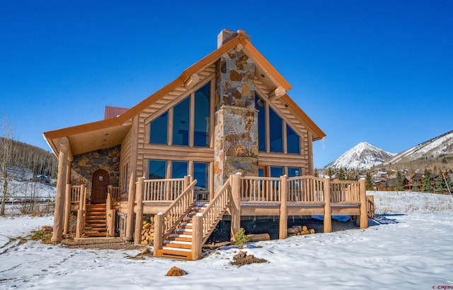 snow covered house with a mountain view