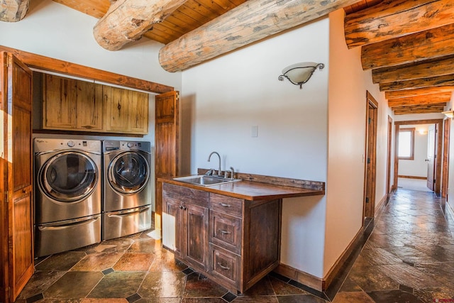 laundry room with cabinets, wood ceiling, sink, and separate washer and dryer