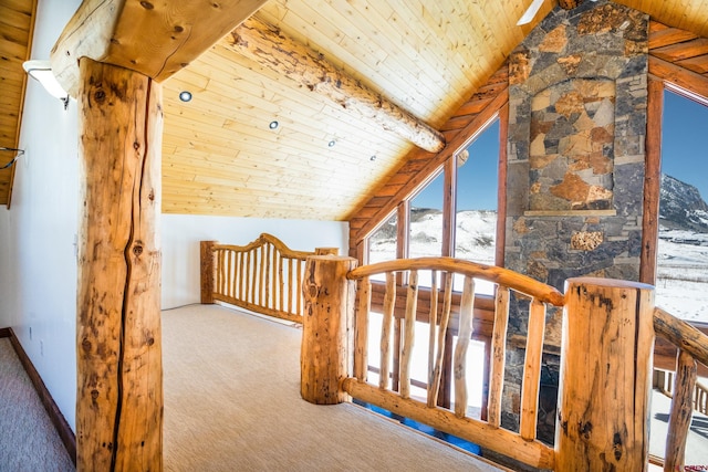 additional living space with lofted ceiling with beams, wooden ceiling, and carpet