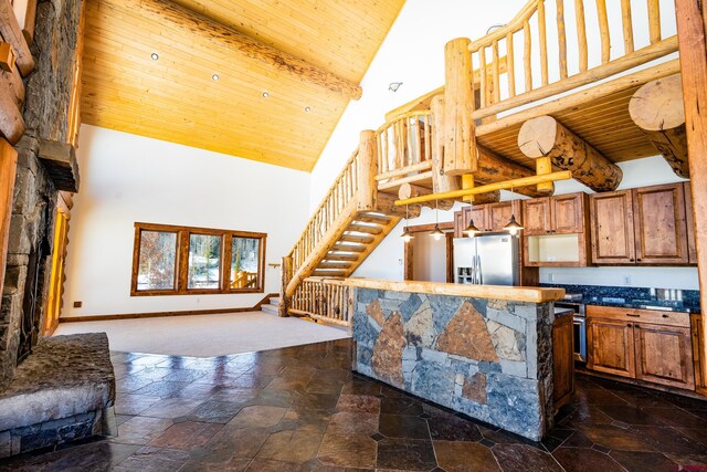 kitchen featuring beamed ceiling, high vaulted ceiling, wooden ceiling, and stainless steel fridge with ice dispenser