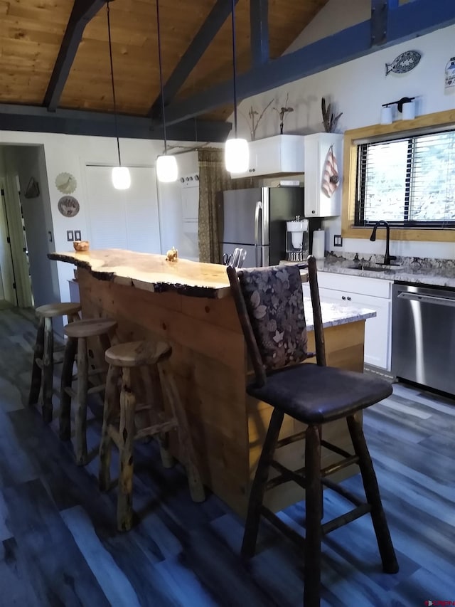 bar featuring dark wood-type flooring, wood ceiling, hanging light fixtures, white cabinetry, and appliances with stainless steel finishes