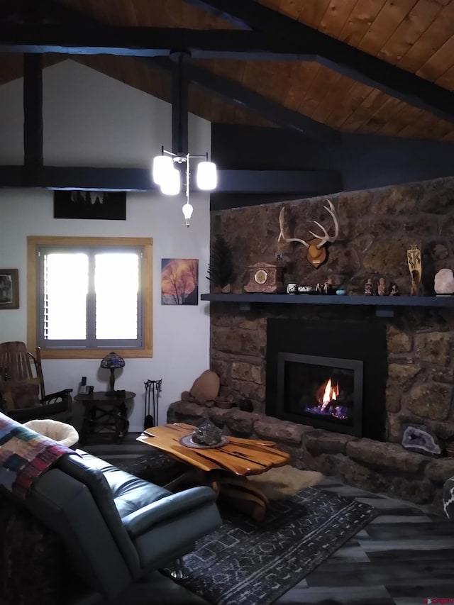 living room featuring beamed ceiling, high vaulted ceiling, hardwood / wood-style floors, a stone fireplace, and wood ceiling