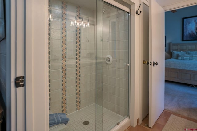 bathroom with tile patterned flooring and a shower with shower door