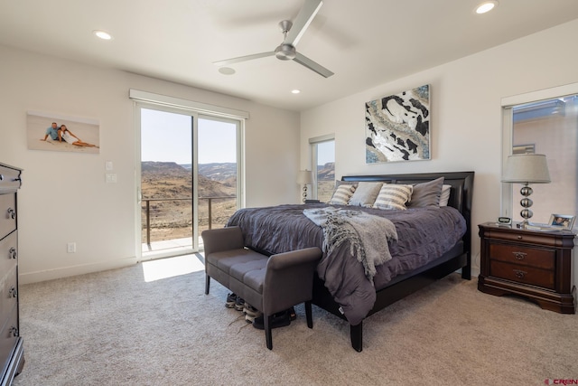 carpeted bedroom with a mountain view, ceiling fan, and access to exterior