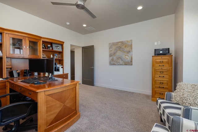 carpeted office space featuring ceiling fan