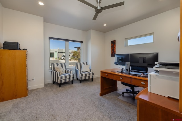 carpeted office with ceiling fan and plenty of natural light