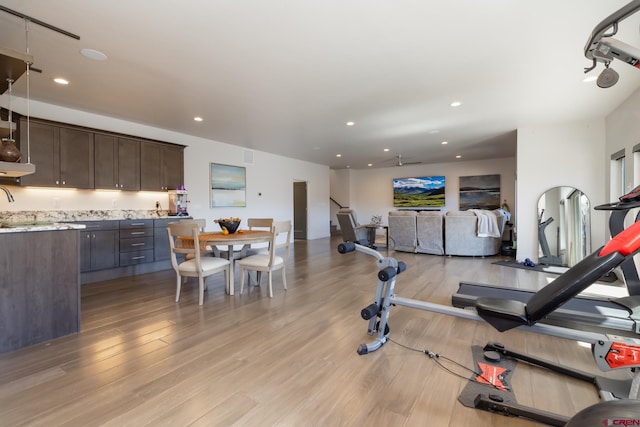 exercise room with light hardwood / wood-style flooring