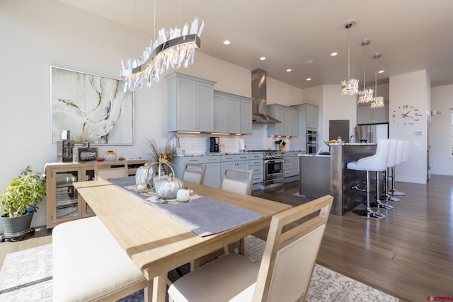 dining room with light hardwood / wood-style floors and a chandelier