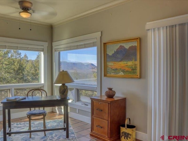 office space featuring ornamental molding, a mountain view, light tile patterned floors, and ceiling fan