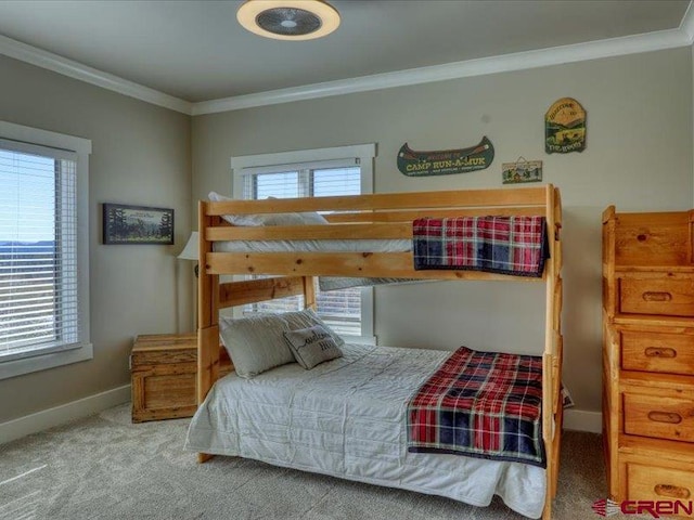 bedroom featuring carpet floors, multiple windows, and crown molding