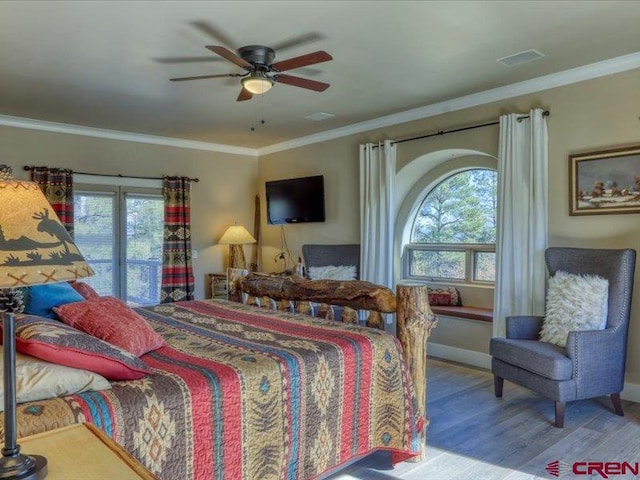 bedroom featuring ceiling fan, multiple windows, crown molding, and wood-type flooring