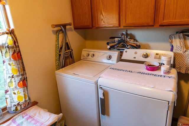 washroom featuring cabinets and independent washer and dryer