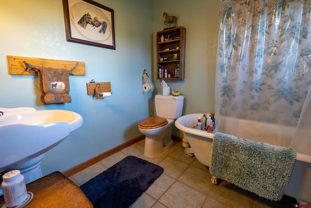 bathroom featuring toilet, sink, and tile patterned floors