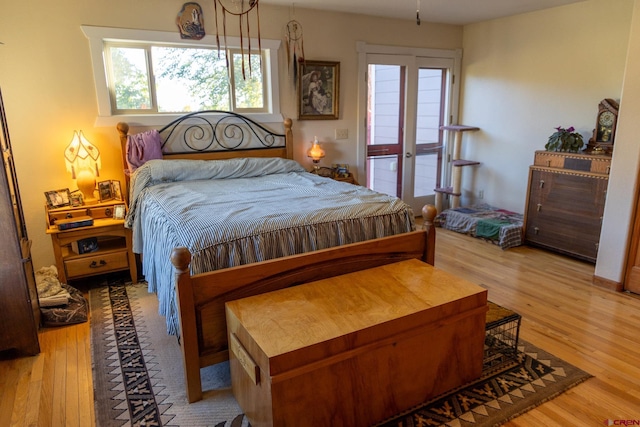 bedroom featuring french doors and light hardwood / wood-style flooring