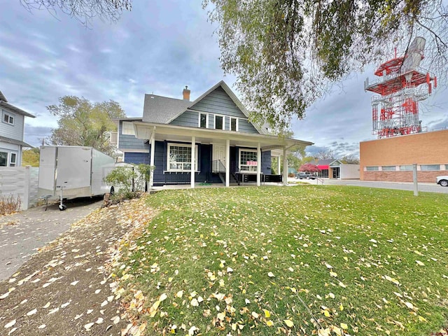 view of front of house with a porch and a front lawn