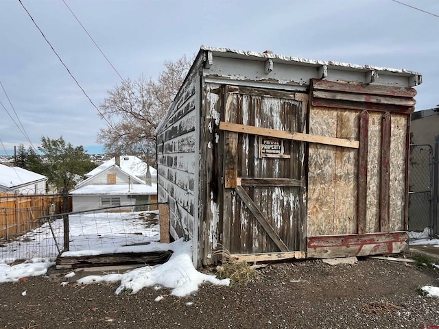 snow covered structure featuring a garage