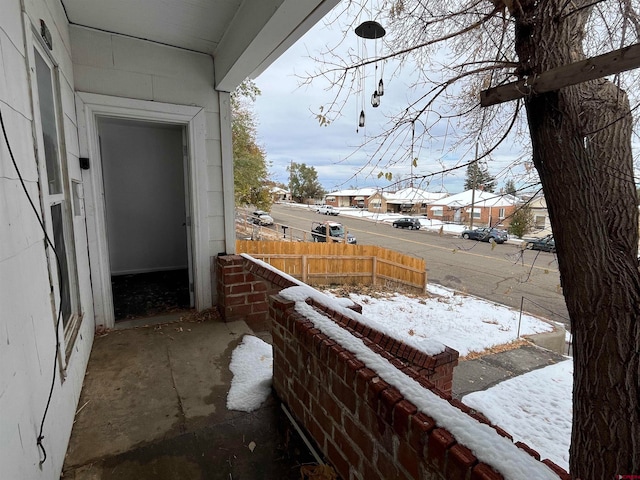 view of snow covered back of property