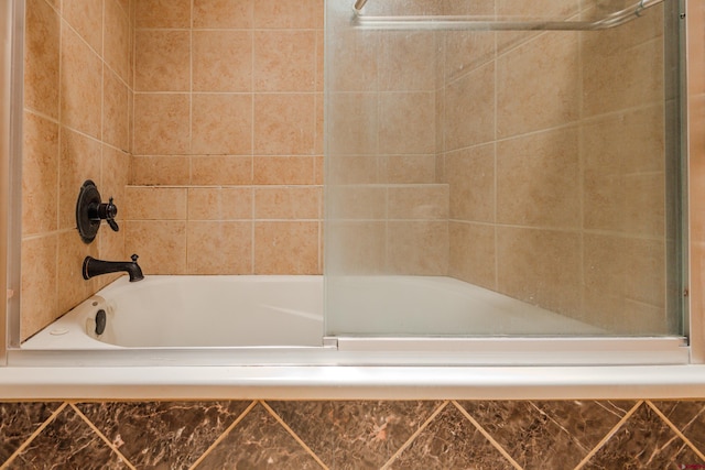 bathroom with shower / bath combination with glass door