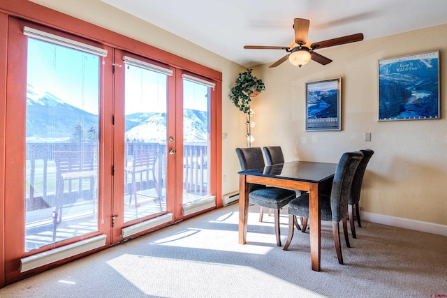 carpeted dining area with french doors and ceiling fan