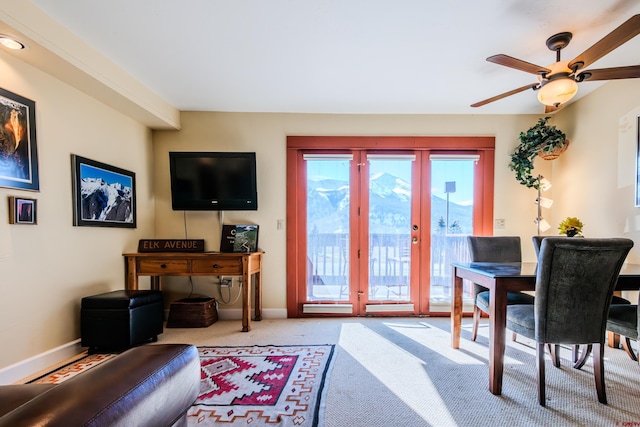 carpeted living room featuring french doors and ceiling fan