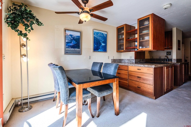 dining space featuring light colored carpet and ceiling fan