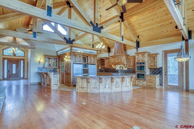 kitchen featuring high vaulted ceiling, a wealth of natural light, and a center island