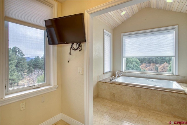 bathroom featuring lofted ceiling, wood ceiling, and tiled bath