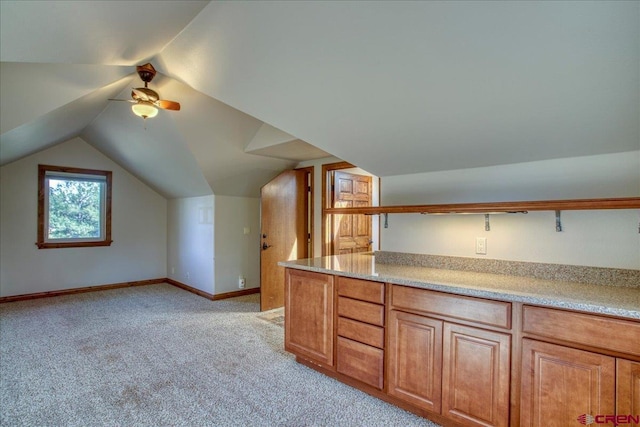 additional living space featuring ceiling fan, light colored carpet, and lofted ceiling