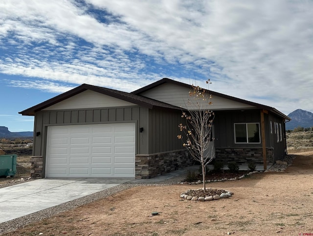 view of front of property featuring a garage and a mountain view