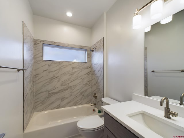 full bathroom featuring toilet, tiled shower / bath combo, and vanity