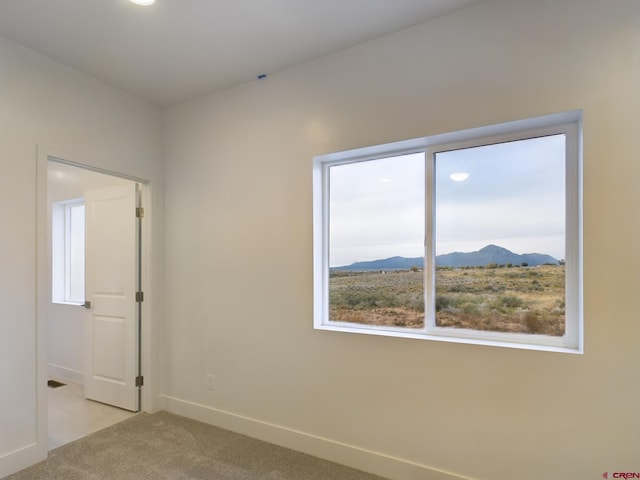 carpeted spare room with a mountain view