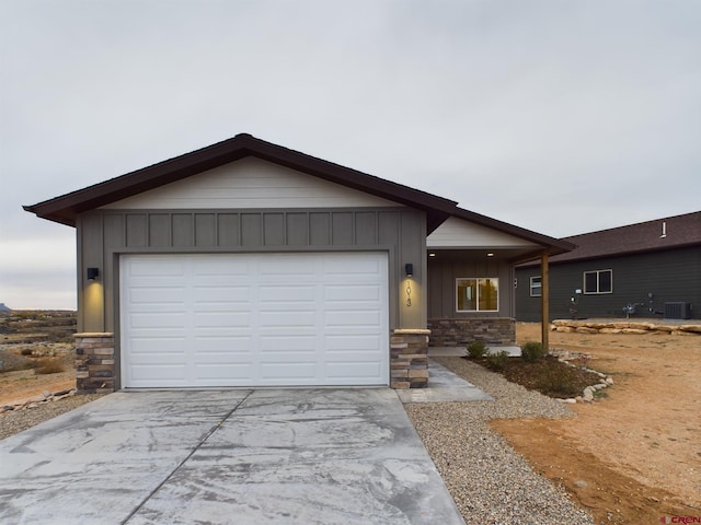 single story home featuring a garage and central air condition unit