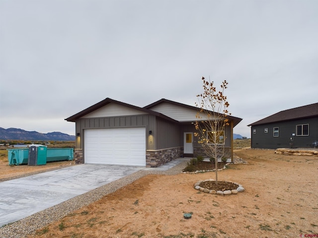 view of front of property with a garage and a mountain view