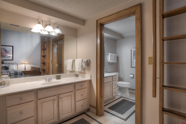 bathroom featuring a textured ceiling, vanity, a notable chandelier, tile patterned floors, and toilet