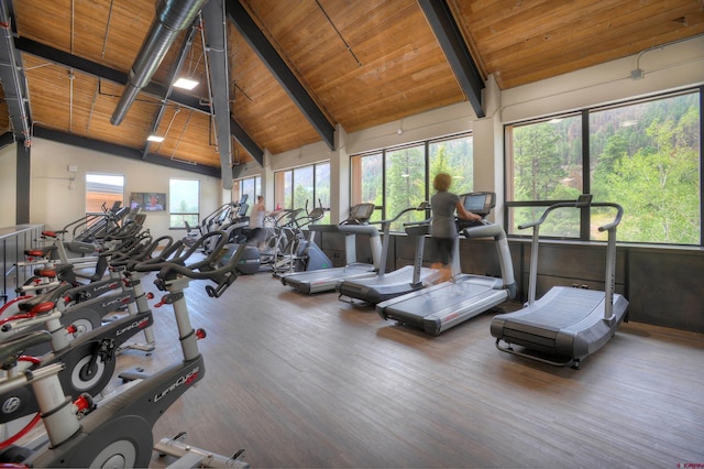 gym with wooden ceiling, hardwood / wood-style flooring, and vaulted ceiling