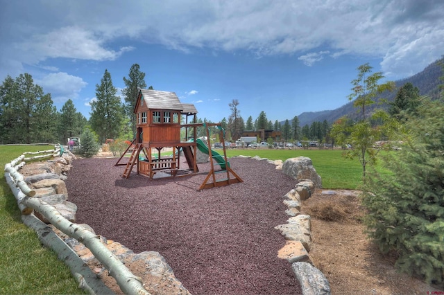 view of play area featuring a lawn and a mountain view