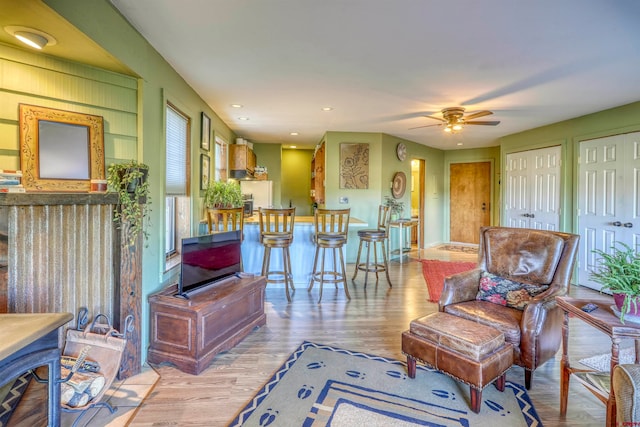 living room with ceiling fan and light hardwood / wood-style floors