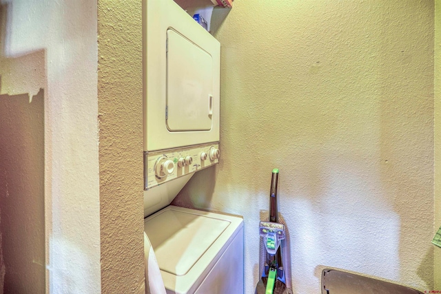 washroom featuring stacked washer / dryer