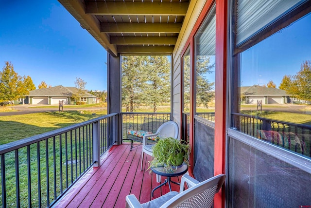 wooden deck featuring a yard