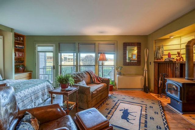 sitting room featuring a wood stove and hardwood / wood-style flooring