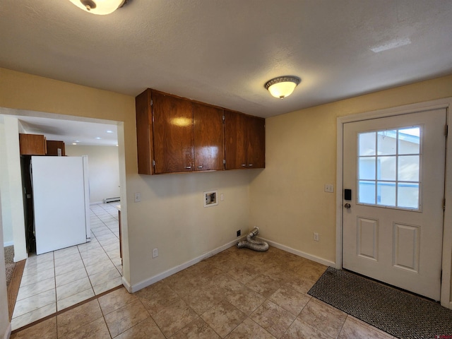 laundry area with cabinets, a textured ceiling, gas dryer hookup, baseboard heating, and washer hookup